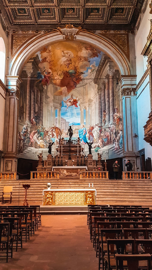 L'altare maggiore della chiesa di santissima annunziata all'interno del museo santa maria della scala. In fondo al centro l'altare con dietro un enorme affresco colorato che arriva fino al soffitto.
