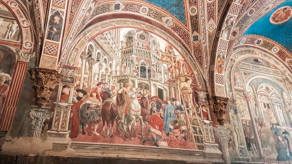 Un primo piano sugli affreschi colorati di una delle sale del museo santa maria della scala. Ogni affresco racconta una storia in particolare ed è correlato ad un soffitto a volta azzurra.